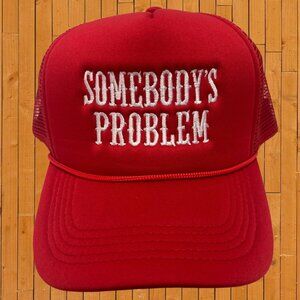 somebody's problem red embroidered trucker hat